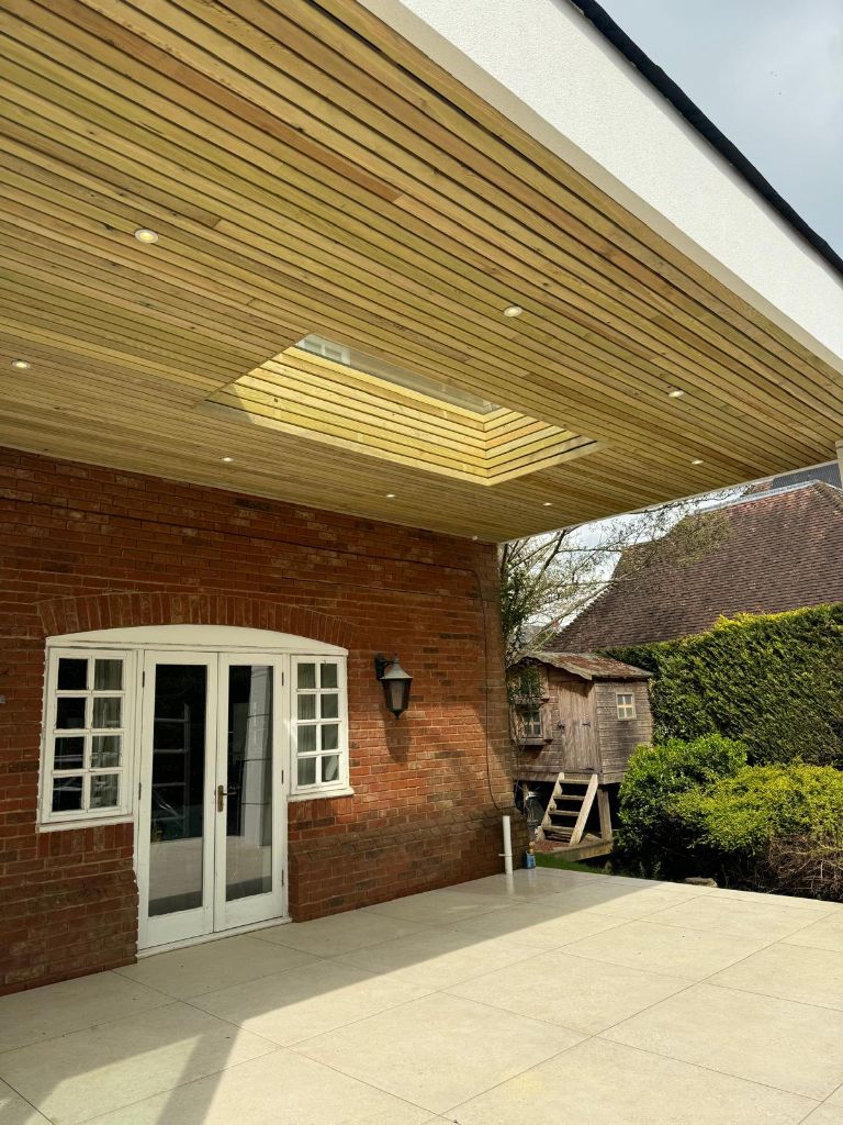 Outdoor covered patio with timber ceiling and recessed lighting installation